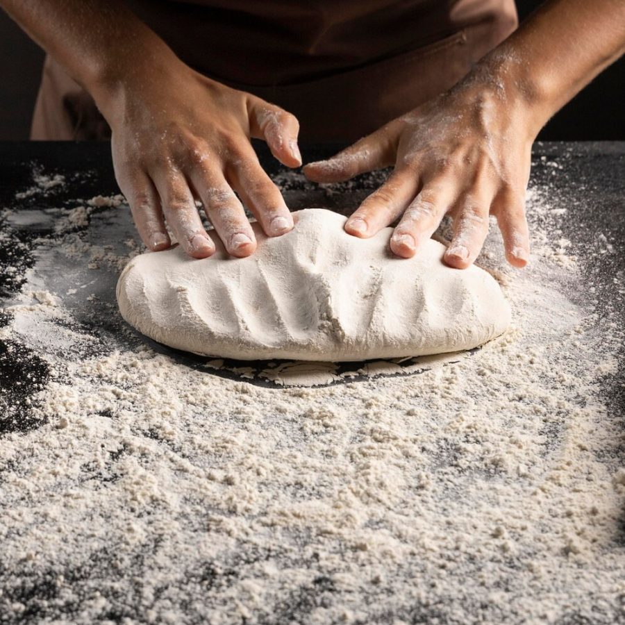 chef-kneading-dough-table_23-2148742165